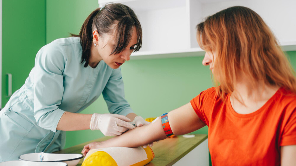 "Doctor explaining vitamin deficiency report from blood test to patient"